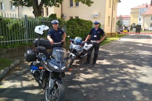 Dwaj policjanci przy swoich motocyklach w komendzie