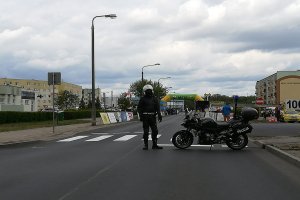 Policjant motocyklista w trakcie zabezpieczenia wyścigu kolarskiego