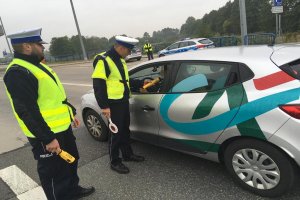 Policjant sprawdza testerem kierowcę na zawartość alkoholu.